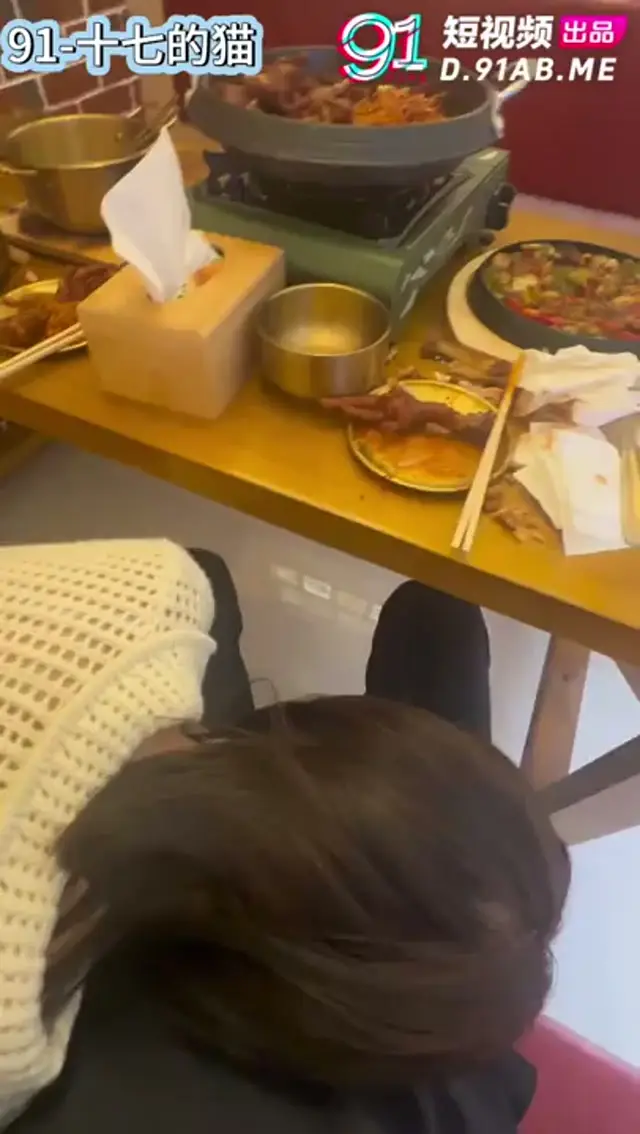Eating meat stick under the table in hotpot restaurant